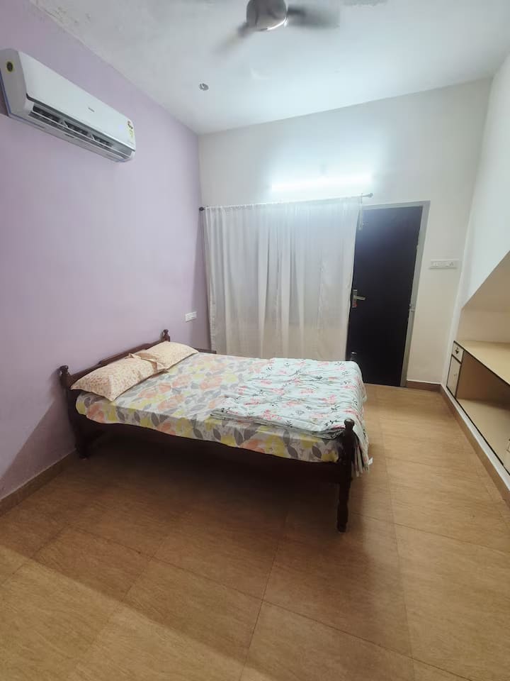A second view of bedroom 3 showing the bed, wardrobe side and air conditioning unit
