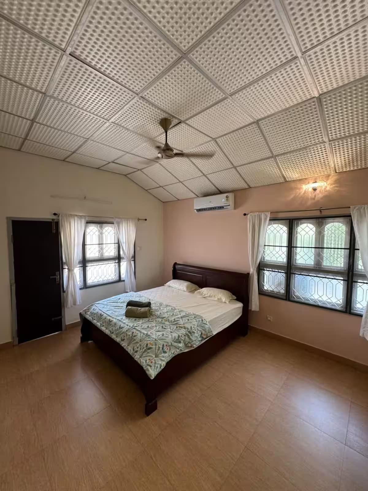Bedroom 2 upstairs, with a king-size bed, air conditioning and a patterned false ceiling