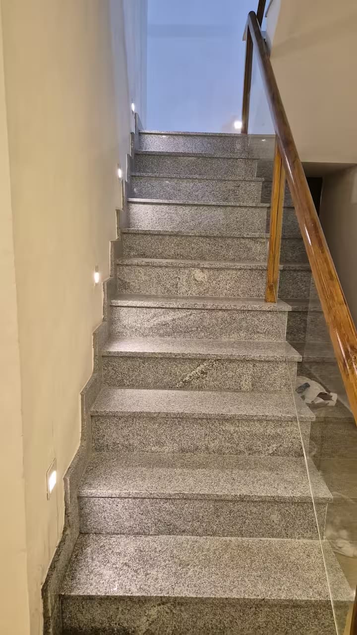The granite staircase rising to the upper floor