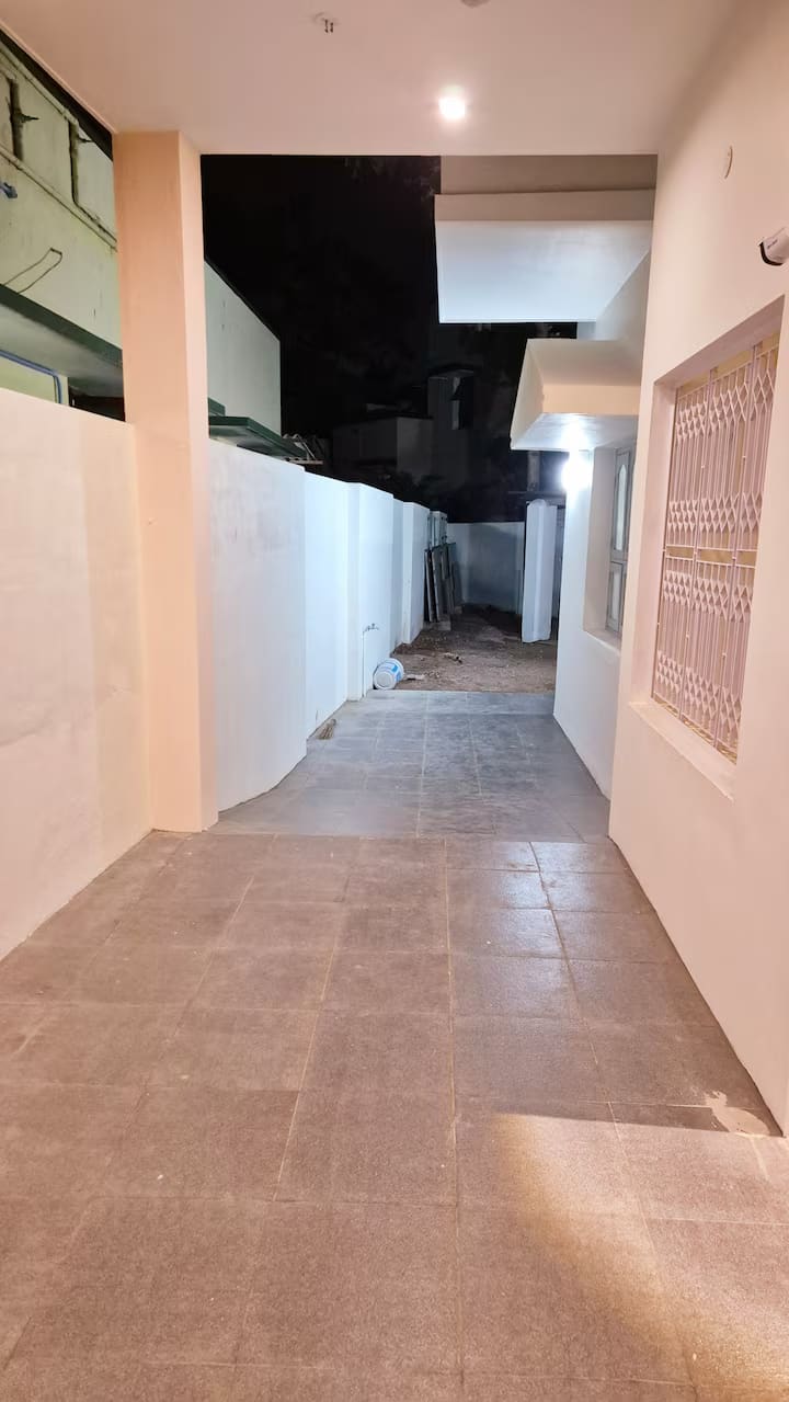 The tiled walkway continuing around the side of the villa