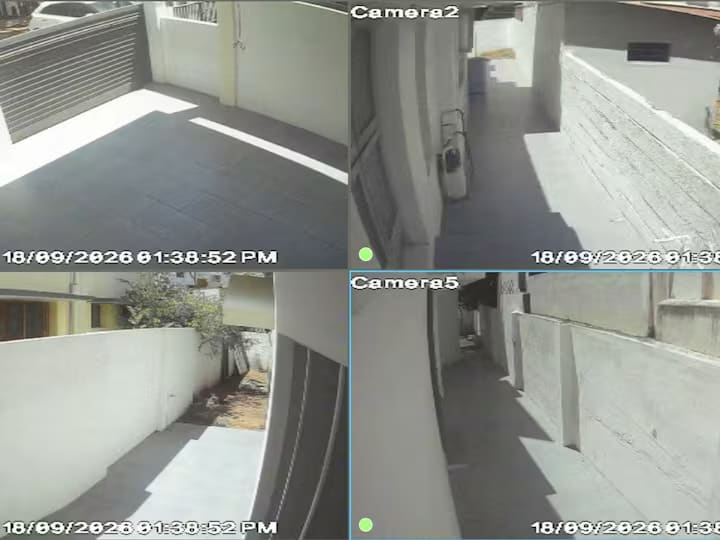 The CCTV monitor showing four exterior camera views of the property