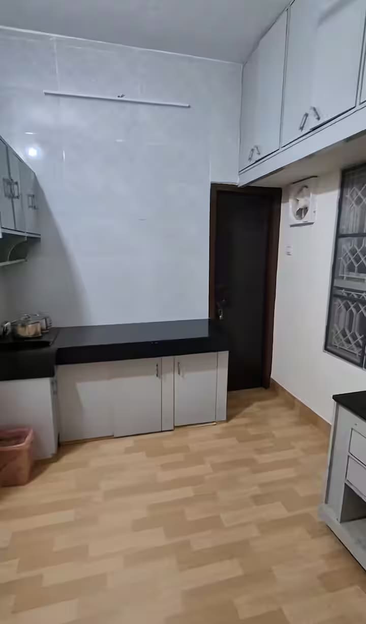 The second run of kitchen units with a utility bench and overhead storage
