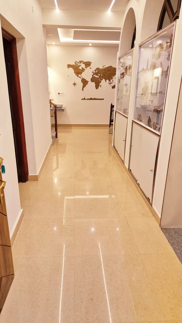 The passage from the living room towards the dining area, lined with display cabinets