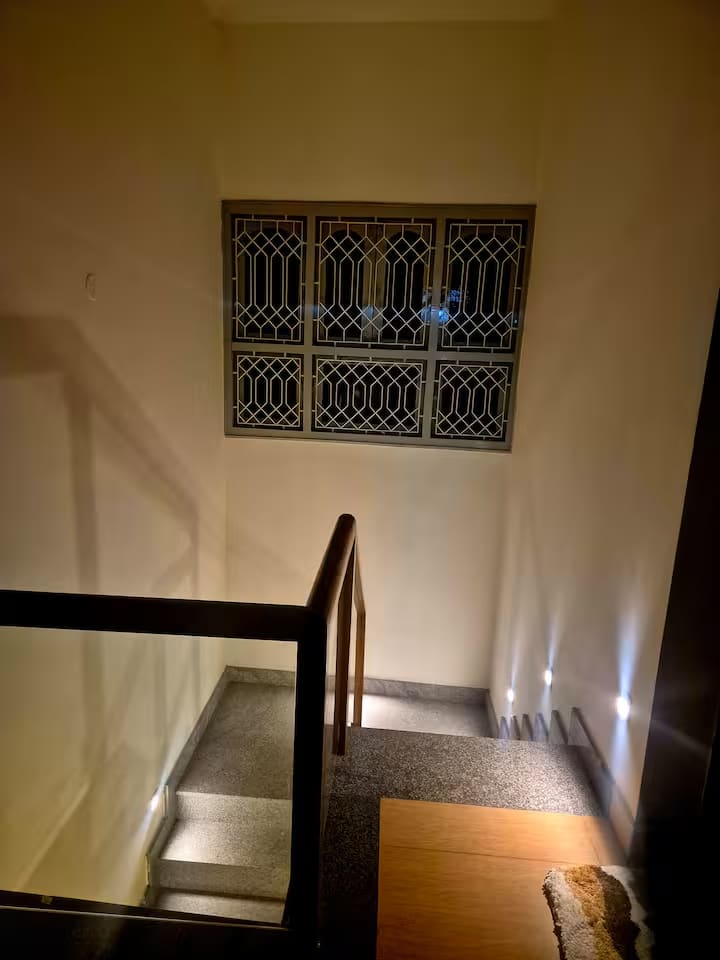 The staircase landing beside a grilled window